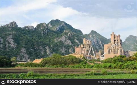 Cement plant with limestone mountain background