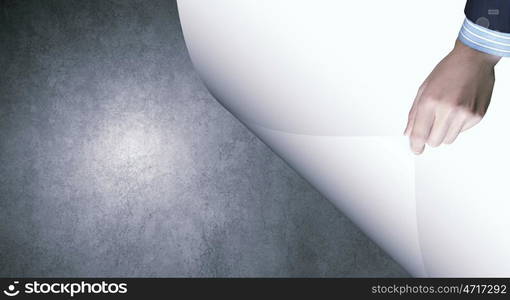 Cement texture. Human hand turning white blank paper page