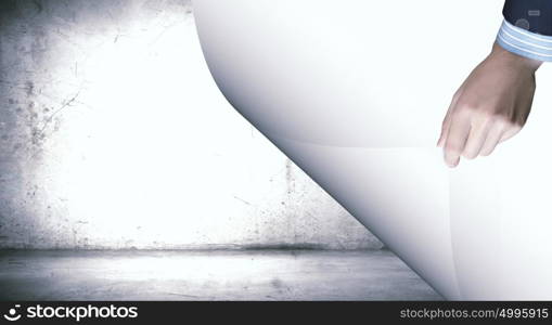 Cement texture. Human hand turning white blank paper page