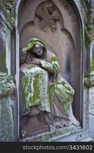 Cemetery. old statue of a grieving woman on a cemetery