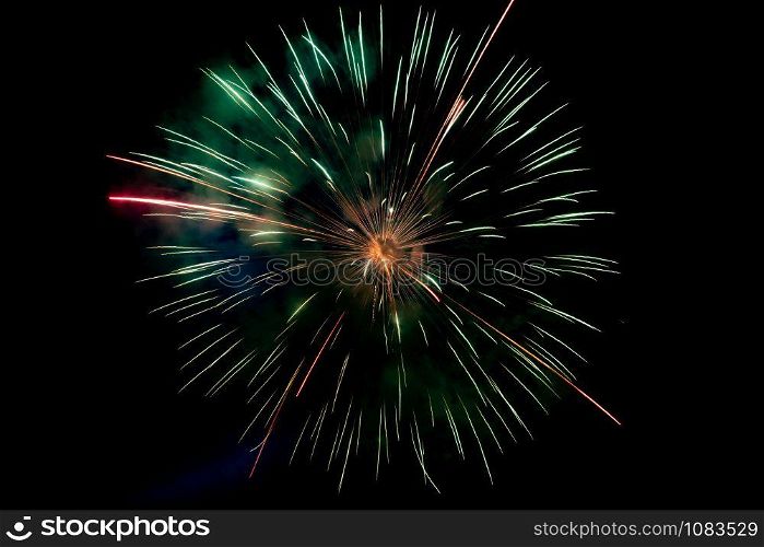 Center Green Orange Sparkling Fireworks Background on Night Scene. Abstract color fireworks background and smoke on sky