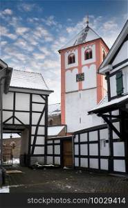 Center of village Odenthal with parish church and old buildings on a winter day, Germany