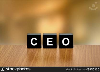 CEO or Chief Executive Officer on black block with blurred background