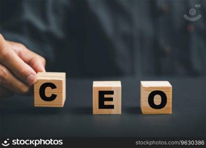 CEO symbol, Businessmans hand picks up wooden cube with CEO text. HR officer searches for leader and CEO. HR manager selects employee. Leader stands out from crowd. HR, HRM, HRD concepts.