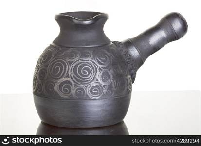 Ceramic, clay cezve on black background