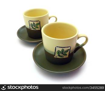 Ceramic cup on a saucer with drawing on a white background