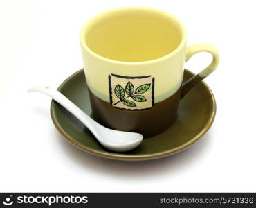 Ceramic cup on a saucer with drawing on a white background