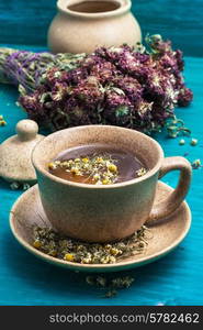 ceramic cup with tea brewed from dried chamomile and medicinal herbs.Selective focus. tea brewed with chamomile in ceramic mugs