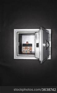 Ceramic house in opened safe