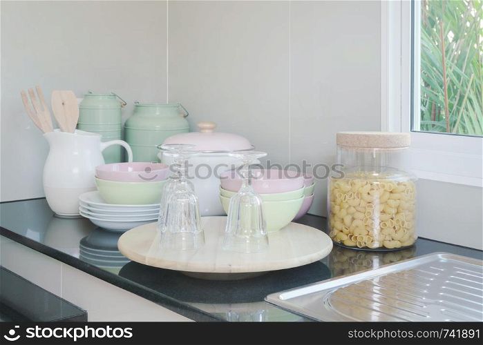 Ceramic kitchenware on black granite counter top in the kitchen