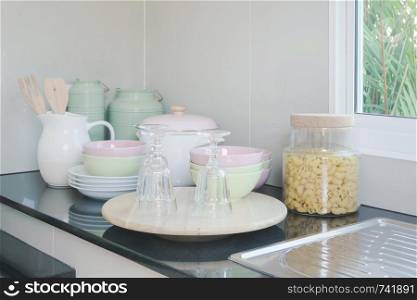 Ceramic kitchenware on black granite counter top in the kitchen
