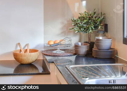 Ceramic kitchenware on the black granite counter top