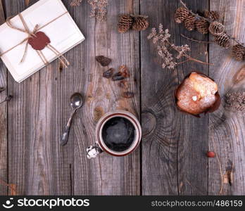 ceramic mug with black coffee, gray wooden table, top view