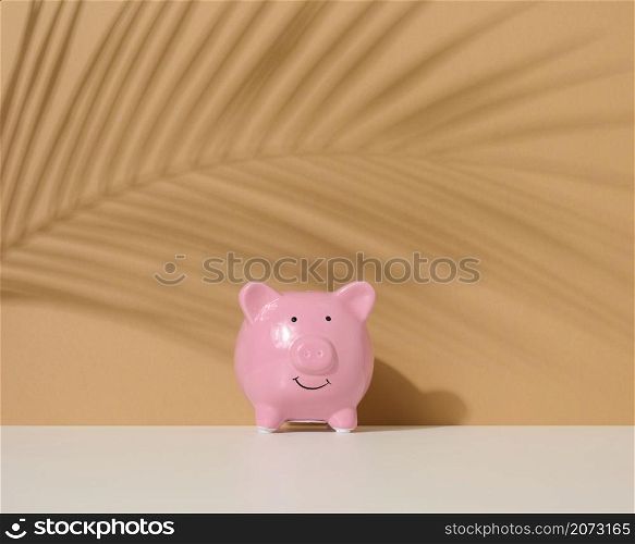 ceramic pink piggy bank on a brown background. Concept of increasing income from bank accounts, savings