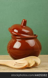 ceramic pot with a wooden spoon old desk