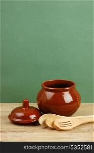 ceramic pot with a wooden spoon old desk
