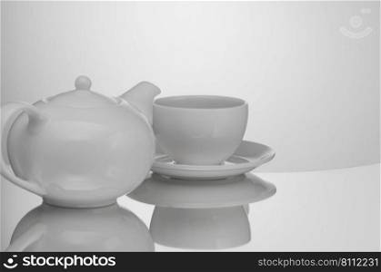 ceramic teapot with cup on light background with reflection. teapot with cup on light background