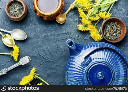 Ceramic teapot with herbal tea from flowering dandelions.Herbal tea from dandelions. Dandelion herbal tea