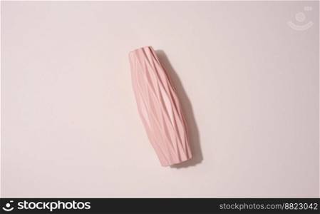 Ceramic vase on a beige background, top view