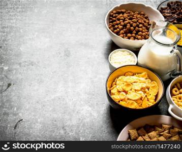 Cereal and a jug of milk. On the stone table.. Cereal and a jug of milk. On stone table.