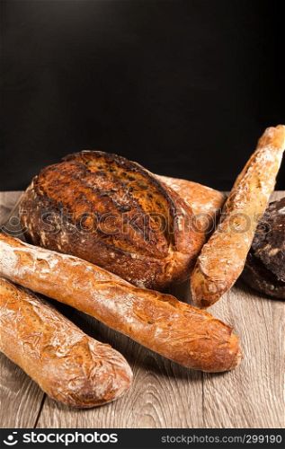 cereal baguette and buckwheat bread on dark background