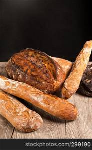 cereal baguette and buckwheat bread on dark background