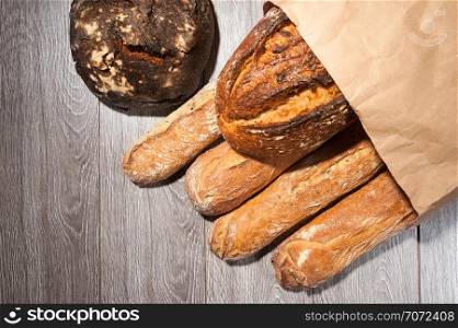 cereal baguette and buckwheat bread on paper bag