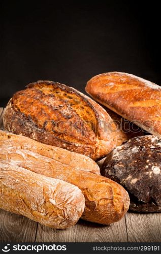 cereal baguette buckwheat bread with onions on dark background
