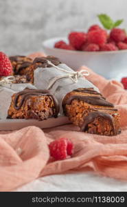 Cereal bars with raspberries on kitchen counter top