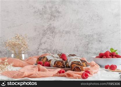 Cereal bars with raspberries on kitchen counter top