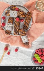 Cereal bars with raspberries on kitchen counter top