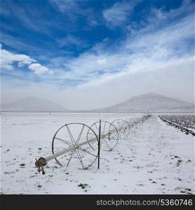 Cereal fields with irrigation wheels with snow in Nevada USA