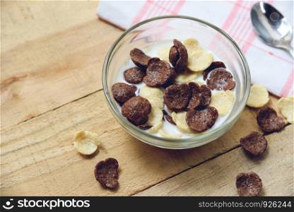 Cereals and Cornflakes in bowl milk cup on wooden table for breakfast healthy food in the morning