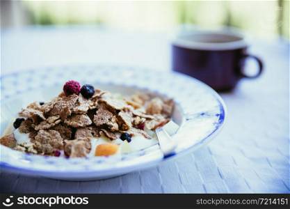 Cereals in the morning: Healthy breakfast with berries and a cup of coffee