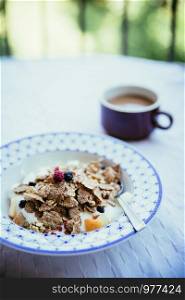 Cereals in the morning: Healthy breakfast with berries and a cup of coffee