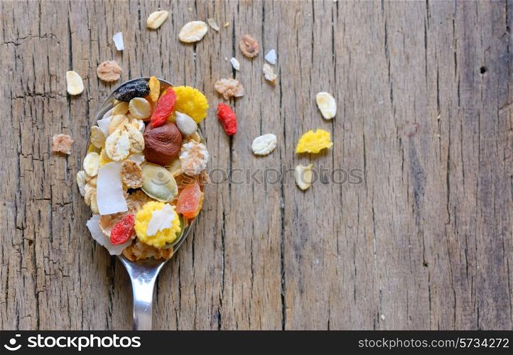 cereals on a spoon over wooden background