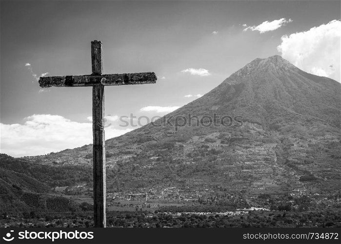 Cerro de la Cruz lookout above the tourist town of Antigua, Guatemala with volcano behind in stunning black and white