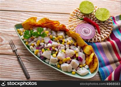 Ceviche peruvian recipe with fried banana and ingredients on wooden table