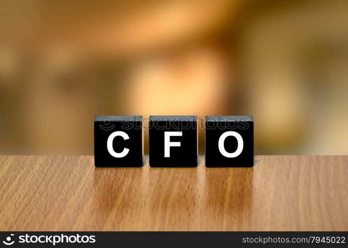 CFO or chief financial officer on black block with blurred background