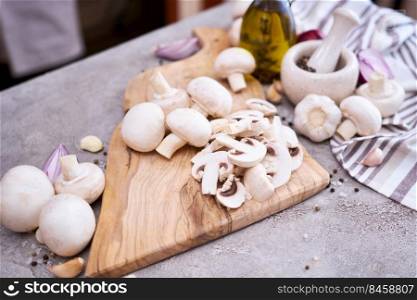 ch&ignon mushrooms on wooden cutting board at domestic kitchen.. ch&ignon mushrooms on wooden cutting board at domestic kitchen