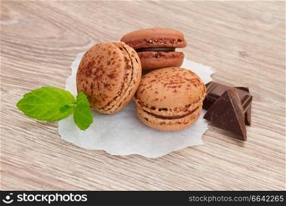 chacolate   macaroons withfresh chocolate bar  on table