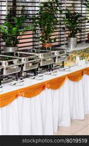 chafing dishes at table ready for wedding catering. catering wedding