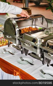 chafing dishes at table ready for wedding catering. catering wedding