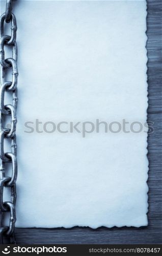 chain and old vintage ancient paper at wooden background