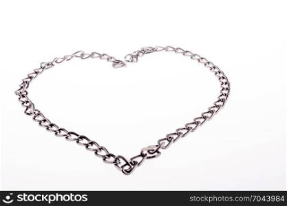Chain form a heart shape and the word LOVE on grass
