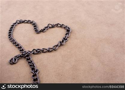 Chain form a heart shape on a brown background