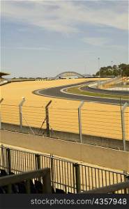 Chain-link fence along with motor racing tracks in a field, Le Mans, France
