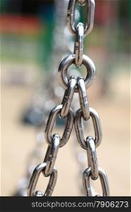 Chain Links closeup of a metal steel chain link segment from a children&#39;s swing set. Outdoors