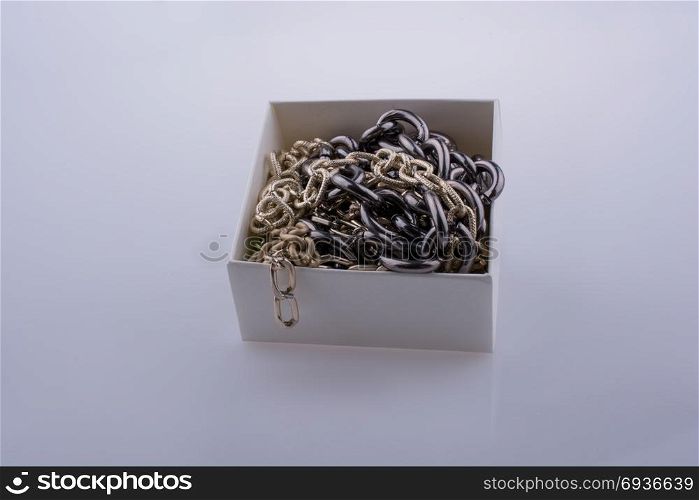 chain made of gold and silver color metal in a white box