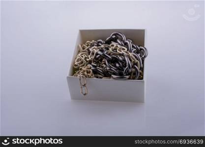 chain made of gold and silver color metal in a white box